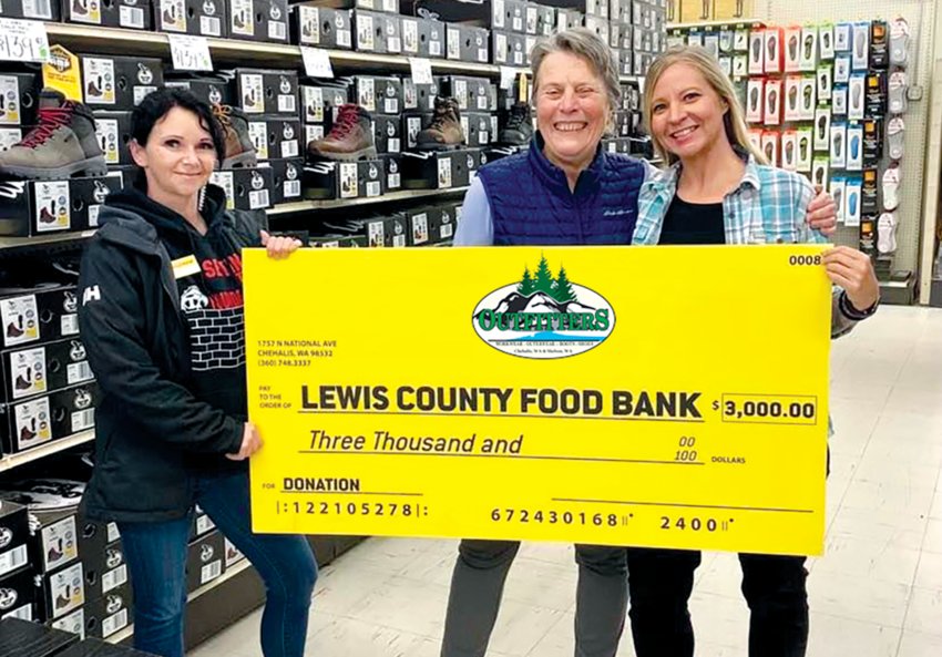 FILE PHOTO &mdash; Pictured from left to right are Ashley Seely, Chehalis Outfitters footwear manager, Sue Barlow, from the Lewis County Food Bank Coalition, and Kelli Erb, Chehalis Outfitters store manager as the business made a donation to the food bank last year.