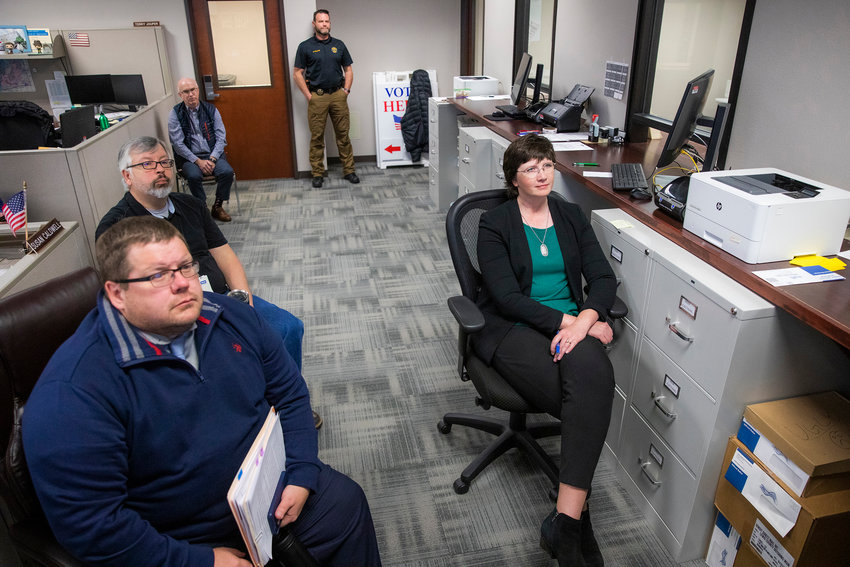 A member of the Lewis County Sheriff&rsquo;s Office stands guard as Prosecutor Jonathan Meyer, Chief Deputy Auditor Tom Stanton, Auditor Larry Grove, and Commissioner Lindsey Pollock attend a Canvasing Board meeting Wednesday morning at the Lewis County Courthouse.