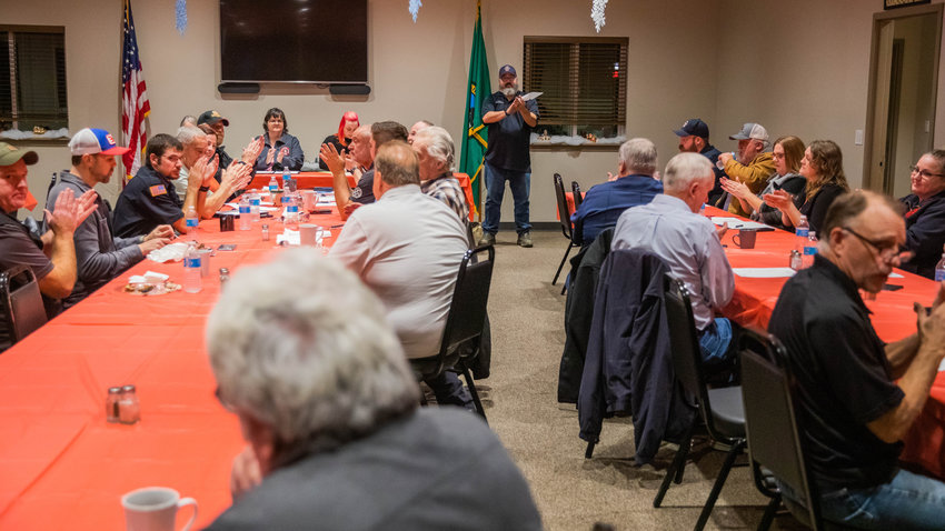 Attendees at a meeting thank visitors from Uncle Jim&rsquo;s Smokehouse for a dinner served Monday night at the Lewis County Fire District 3 building in Mossyrock.