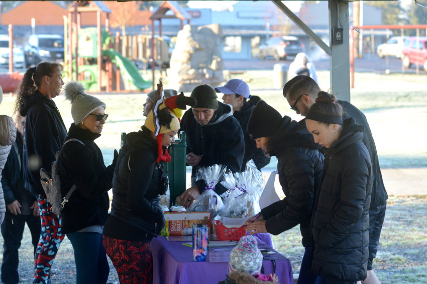 Participants in Yelm Anytime Fitness&rsquo;s Thanksgiving turkey trot check in prior to the event&rsquo;s start in this file photo.