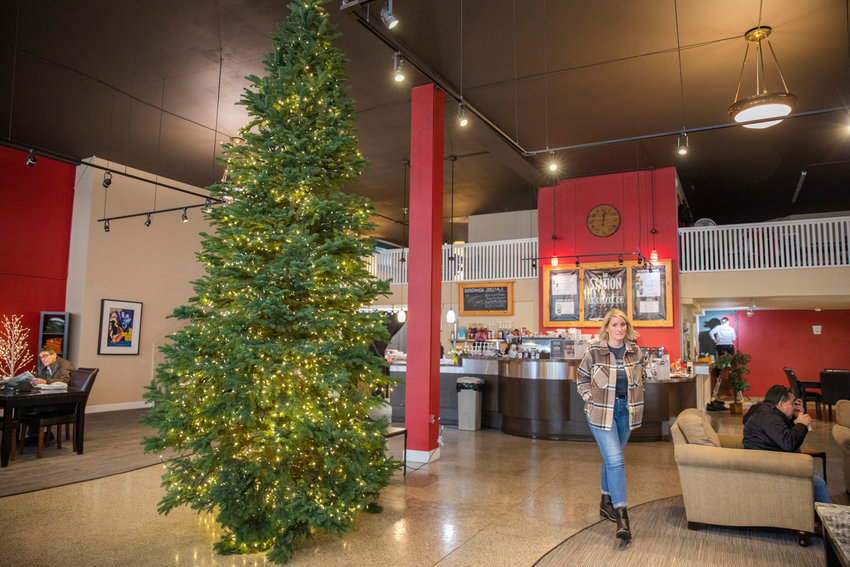A large Christmas tree awaits more decorations as crews at Lewis County Coffee Co. paint the walls and prepare the interior for holiday celebrations Wednesday morning in Centralia.