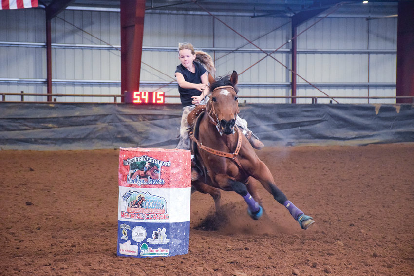 A contestant in Clark County Saddle Club&rsquo;s Dec. 3 barrel race rounds one of the turns during the first set of competitions.