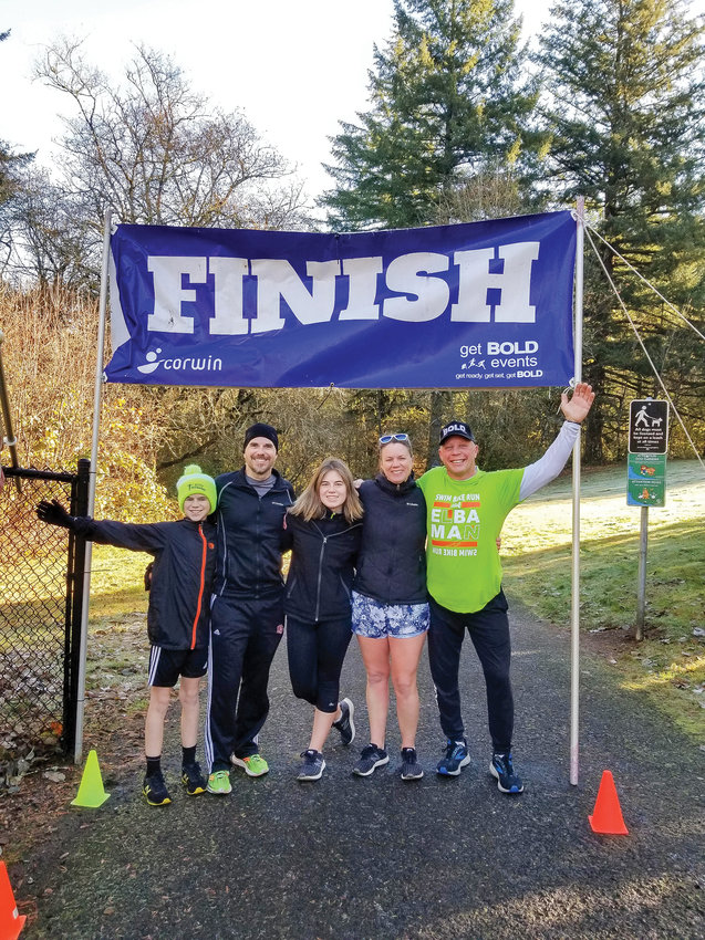 Elba Benzler, right, alongside other participants in the 2022 Thanksgiving Fun Run pose at the finish line.