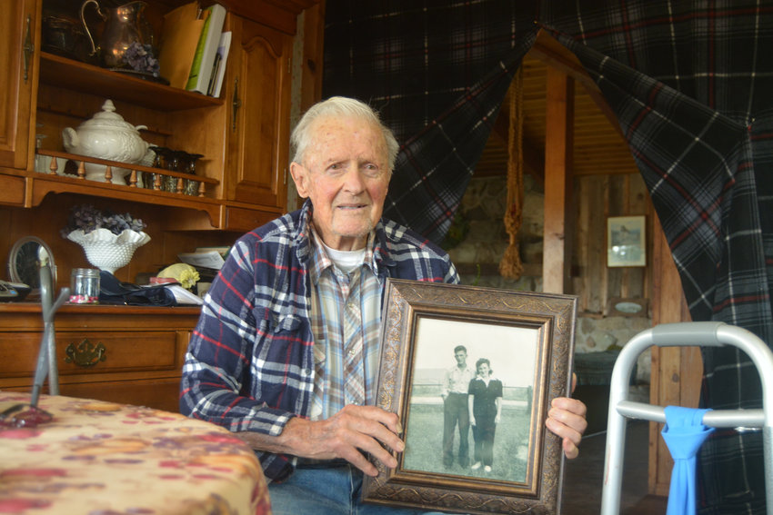 Willis Herness poses with a photo from his engagement with his late wife Eleanor. The two were married for over 70 years. Herness recently celebrated his 100th birthday.