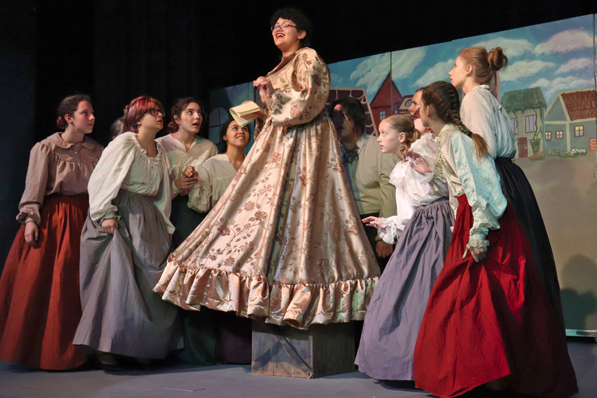 The townsfolk gather around Lady Pinkleton, played by Savannah Bryant, as they perform the number &ldquo;The Prince is Giving a Ball&rdquo; during a dress rehearsal of Cinderella on stage at W.F. West High School on Tuesday.