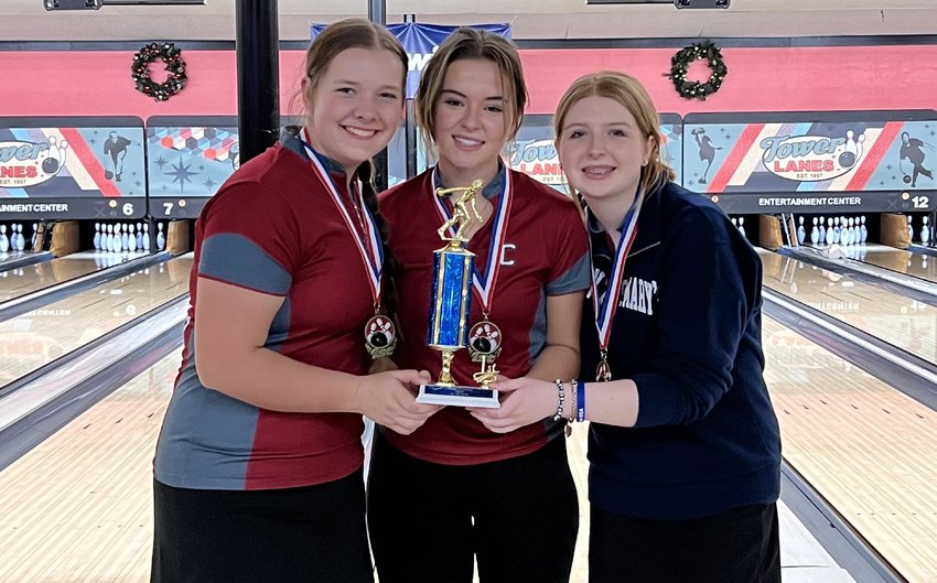 From left to right, Savannah Hawkins, Clara Bunker, and Piper Chalmers pose with the Tower Classic tournament championship trophy at Tower Lanes in Tacoma.