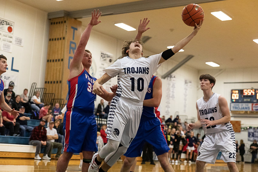 Pe Ell forward Tristan Baker throws up a reverse layup against Willapa Valley Dec. 9.