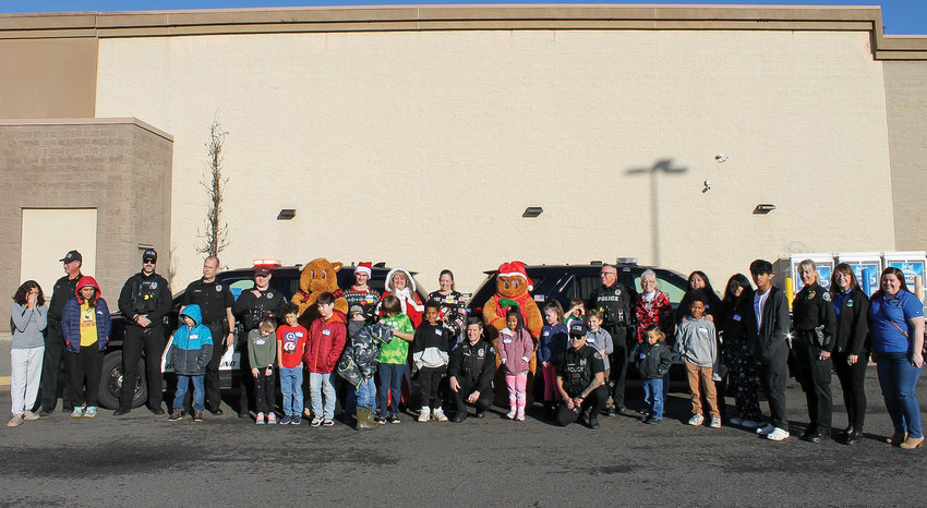 Participants in the Dec. 3 Shop with a Cop event at the Walmart in Battle Ground are pictured.
