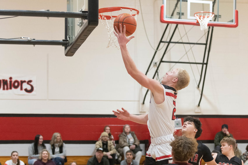 Austin Gonia rises up to the rim during the first quarter of Tenino's game against Ocosta on Dec. 21