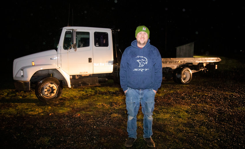 Jack Franks smiles for a photo in front of his tow truck Tuesday evening in Onalaska.