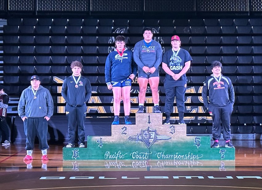 W.F. West 285-pound champion Daniel Matagi stands on the podium after taking the title at the Pac Coast Wrestling Championships at Hudson's Bay High School this week.