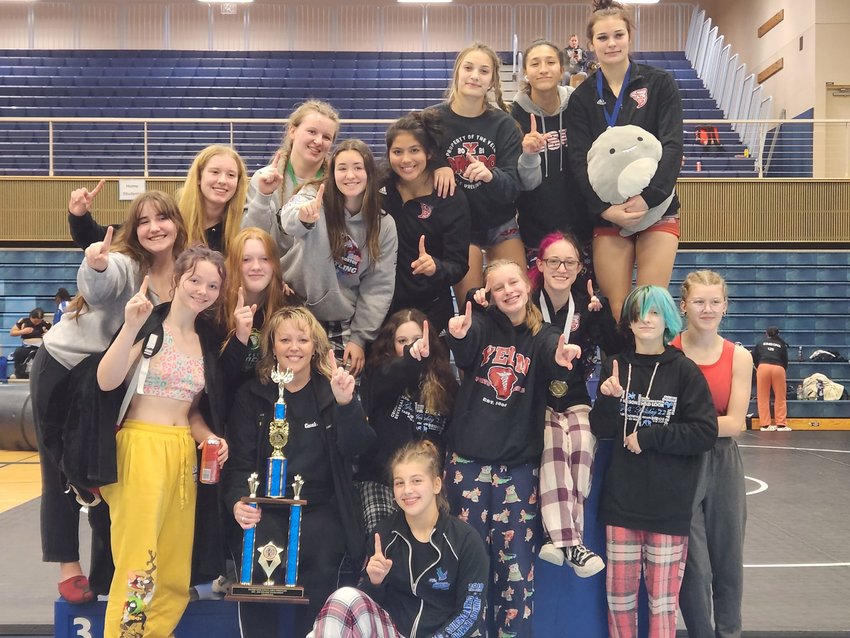 The Yelm girls wrestling team poses with the first place trophy from the Rogers Holiday Tournament.