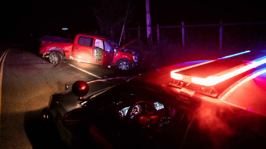 Deputy Andrew Yocom, with the Lewis County Sheriff&rsquo;s Office, blocks a portion of Centralia Alpha Road near the North Fork Road intersection Monday evening following a two vehicle crash where four patients were transported, two from each vehicle, to Providence Centralia Hospital with minor injuries, according to Yocom.