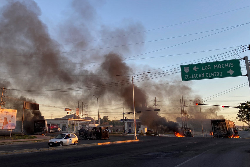 Burning vehicles are seen in the street during an operation to arrest the son of Joaquin &quot;El Chapo&quot; Guzman, Ovidio Guzman, in Culiacan, Sinaloa state, Mexico, on Thursday, Jan. 5, 2023. (Marcos Vizcarra/AFP/Getty Images/TNS)