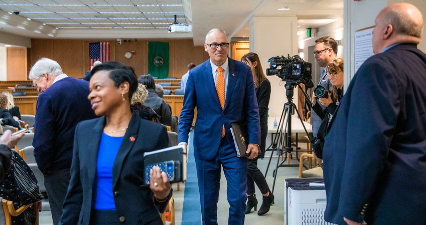 Governor Jay Inslee looks on while walking out of a room inside the John A. Cherberg Building in Olympia on Thursday after answering questions from members of the press.