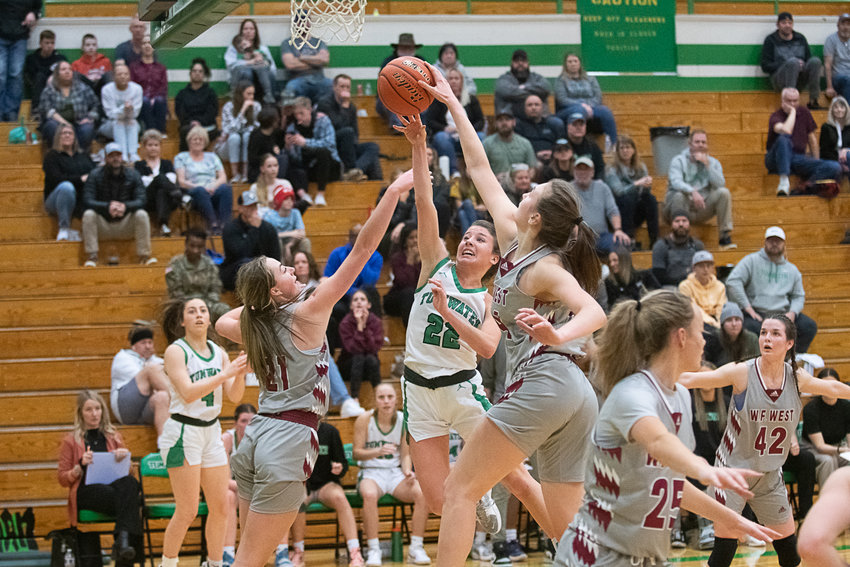 W.F. West's Julia Dalan packs Tumwater guard Regan Brewer's attempt in the lane away for one of her 12 blocks during the Bearcats' 53-37 win over the T-Birds on Jan. 10.
