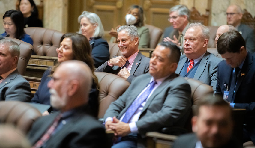 Senator Jeff Wilson smiles while attending Gov. Jay Inlsee&rsquo;s 2023 State of the State speech alongside State Rep. Jim Walsh last January at the Capitol.
