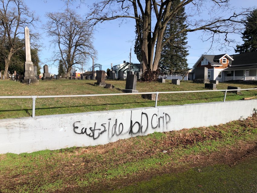 Graffiti is pictured along a wall at Washington Lawn Cemetery in Centralia on Tuesday afternoon.