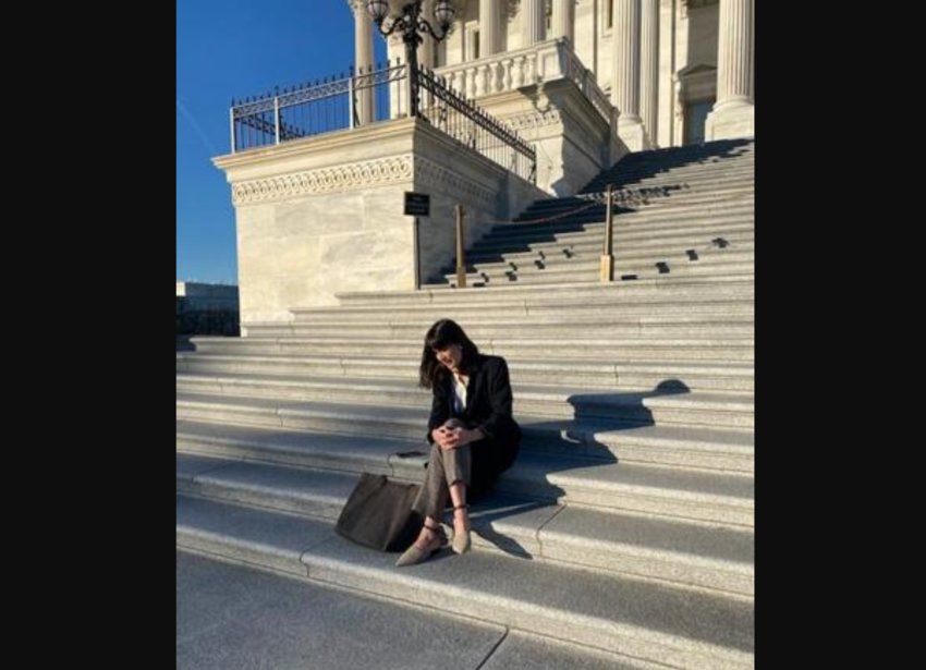 Marie Gluesenkamp Perez sits on the steps outside Congress after being named the winner of the 3rd District race.