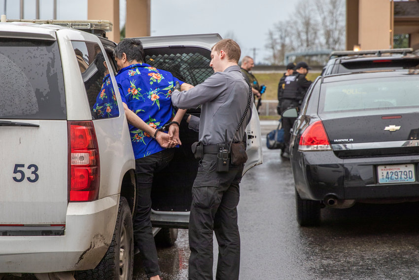 Jose T. Diaz, 57, of Centralia, is taken into custody outside the Peppermill Empress Inn Thursday afternoon in Centralia.