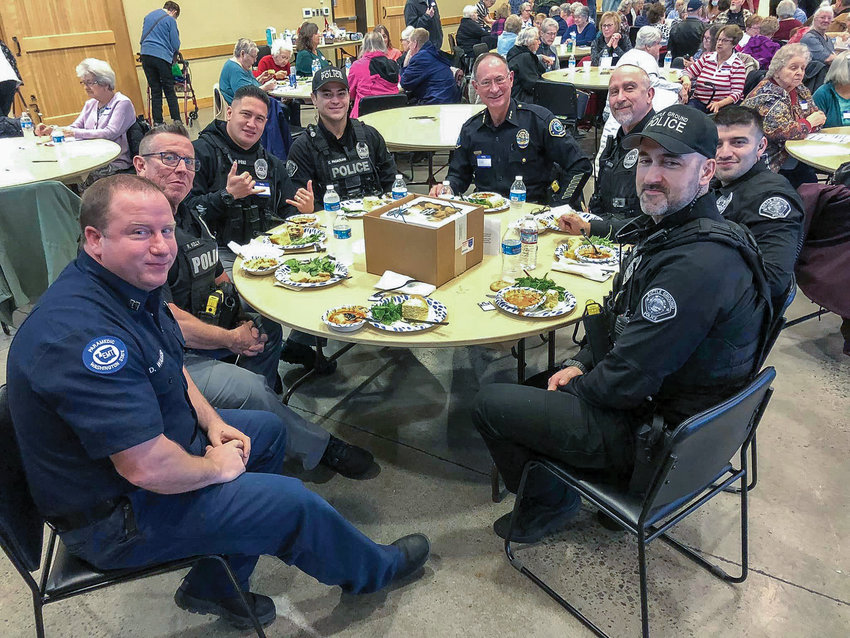 Officers with the Battle Ground Police Department enjoy lunch at the Battle Ground Senior Citizens&rsquo; monthly luncheon on Jan. 9.