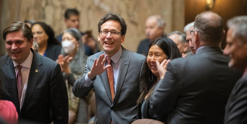 Washington state Attorney General Bob Ferguson smiles and waves as he enters the House Chambers in Olympia on Tuesday, Jan. 10, 2023, prior to the beginning of the State of the State speech.