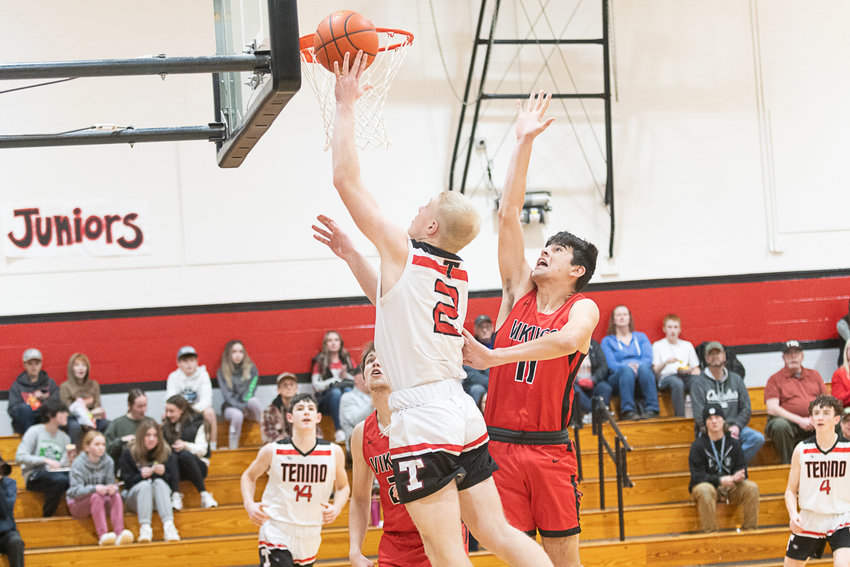 Austin Gonia goes up for two points as Mossyrock's Zackary Munoz comes flying in during the first quarter of Tenino's 65-46 win over the Vikings on Jan. 18.