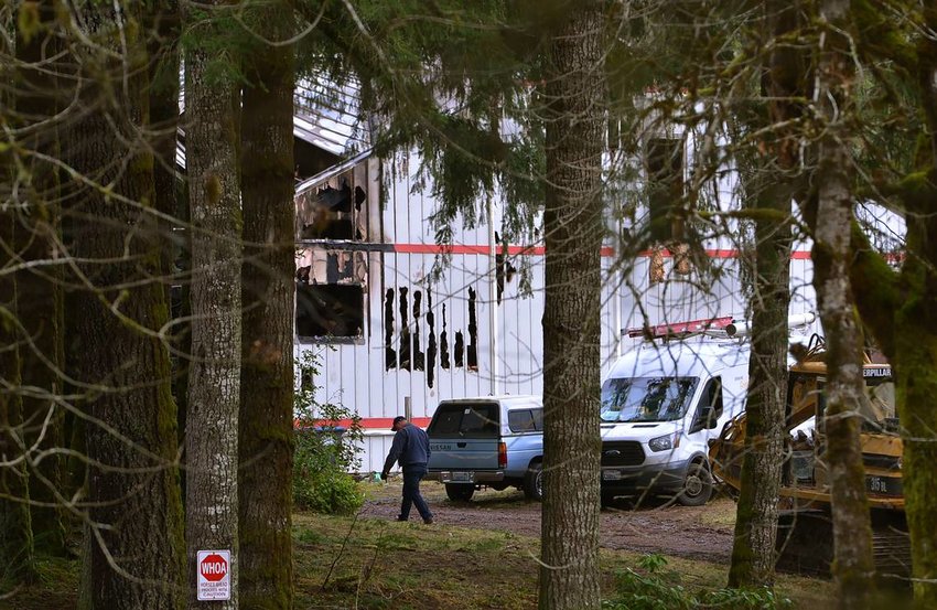 Investigators representing numerous agencies converge on a gutted home in the 8800 block of Sherman Valley Road SW near Capitol Peak in west Thurston County on Sunday, Jan. 22, after an early morning fire on Saturday killed five people inside the home.