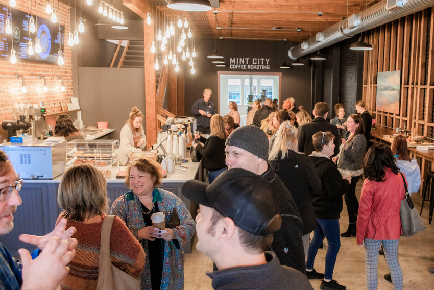 FILE PHOTO &mdash; Crowds gather and mingle at Mint City Coffee before a ribbon-cutting ceremony last January.