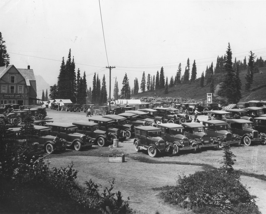 From the Washington State Archives: Paradise Camp Lodge opened at Paradise meadows in 1918. The facility continued in use until it was demolished by the park to expand parking facilities in the mid 1950s. The current Jackson Visitor Center stands on the site. From a handwritten note included with this photo: &quot;Ye ancient gas chariots of July 19, 1925. Parked in Paradise Park after a long dusty ride from Seattle Tacoma and what have U.S.A. 'They traveled slowly - roughly and dangerously' like the pioneer of long, long ago.&quot;