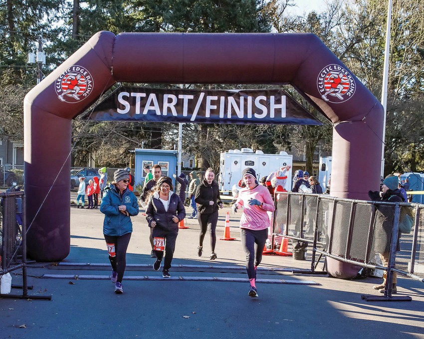 Participants cross the finish line in front of Clark Public Utilities&rsquo; office on Fort Vancouver Way during the ninth annual Race for Warmth on Sunday, Jan. 29.