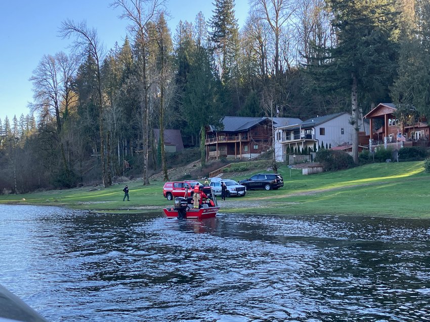 Search personnel look for one of two people whose boat capsized on the North Fork Lewis River on Jan. 29