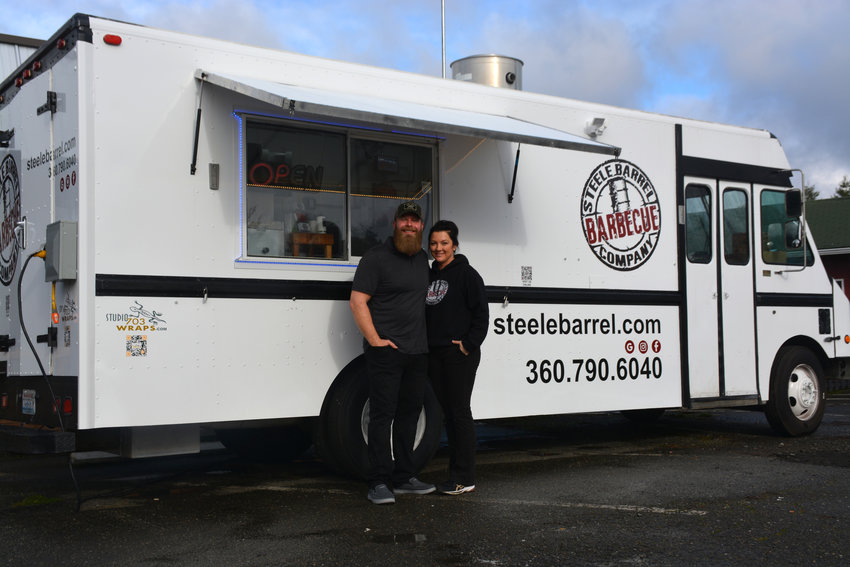 Steele and Ksea Clayton pose in front of their Steele Barrel Barbecue food truck.