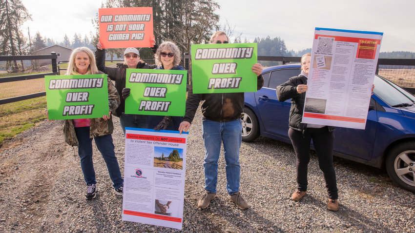 From left, Kathy Taylor, Suzanne Brown, Rachelle Reinitz, a neighbor who brought extra signs and wished to stay anonymous, and Kim Crist who lives across the street, gather for a demonstration outside of the Supreme Living facility located at 2813 140th Ave. SW in Tenino on Wednesday. Officials with the state were scheduled to hold a webinar to address the concerns of area residents on Wednesday night. Coverage of the webinar will be included in Saturday&rsquo;s edition of The Chronicle.