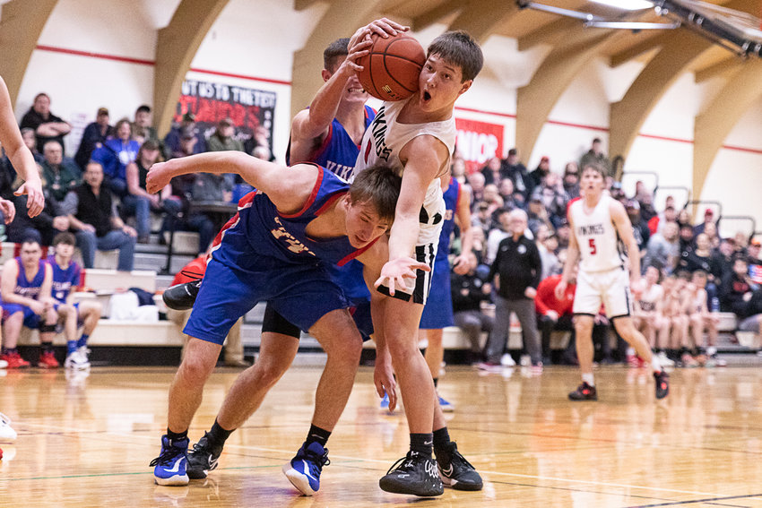 Mossyrock guard Keegan Kolb looks to an official for a foul call after getting tangled up with Willapa Valley's Derek Fluke Feb. 3.