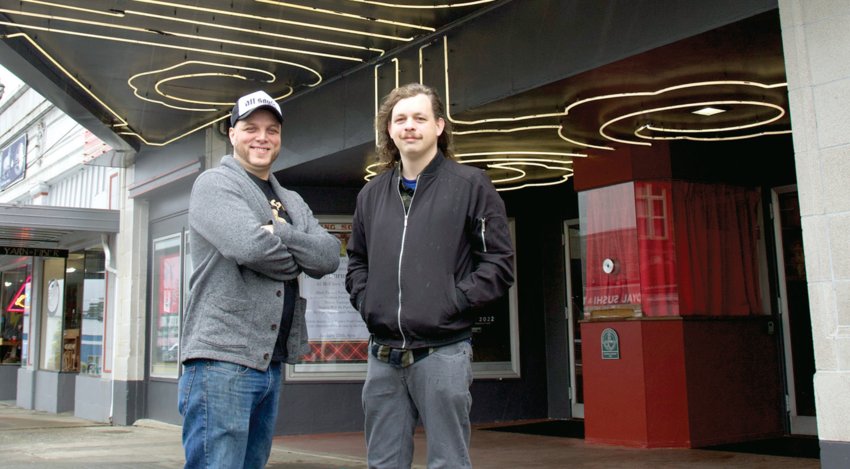 McFiler&rsquo;s Chehalis Theater owner Tim Filer, left, and HUB Comedy producer Gabe Botten stand beneath a sign advertising Kabir Singh&rsquo;s comedy show in Chehalis on Tuesday.