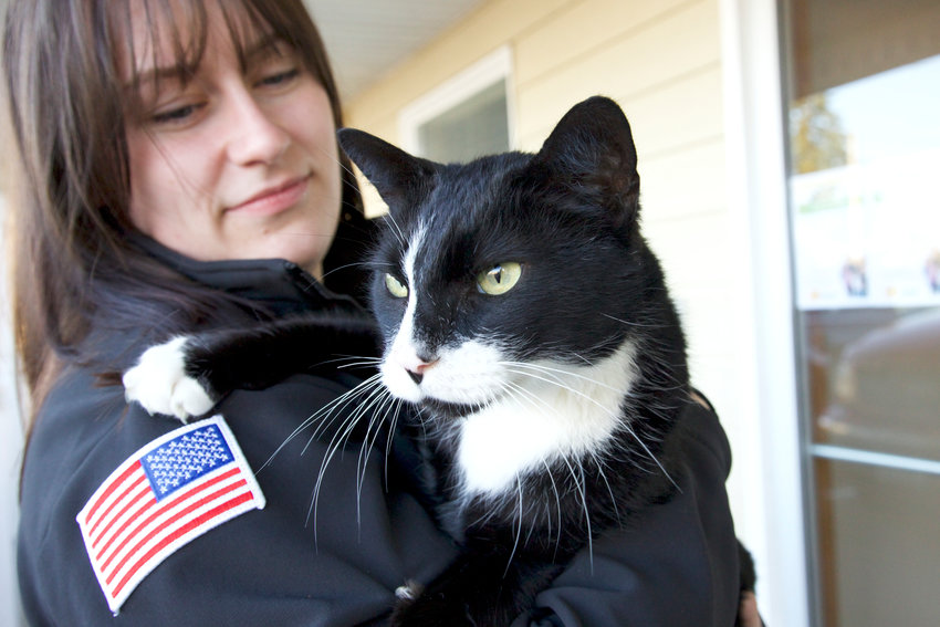Lewis County Fire District 5 firefighter/EMT Jenna Gawrys holds a rescued female tuxedo cat in Napavine on Thursday.&nbsp;