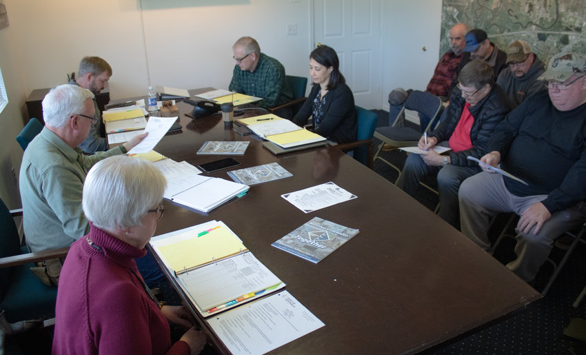 FILE PHOTO &mdash; Port of Centralia commissioners discuss a resolution amending public comment time at their meetings during a meeting in February.