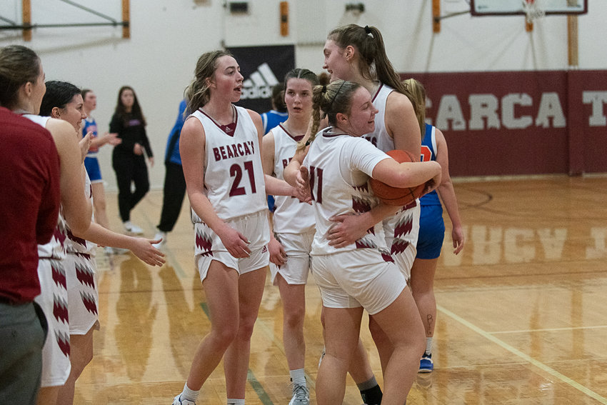 Lena Fragner (11) hugs Julia Dalan as the final buzzer sounds on W.F. West's 62-43 win over Ridgefield on Feb. 10 in the quarterfinals of the district tournament.