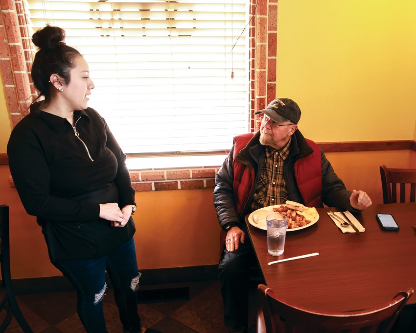 Lupita Roblez, left, serves Battle Ground resident, Bill Suefert, his breakfast at Julio&rsquo;s Coffee and Breakfast in Battle Ground.