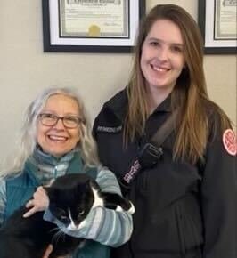 Gizelle, left, holds a rescued female tuxedo cat alongside District 5 firefighter and medic Caity Hoye at the District 5 station in Napavine over the weekend. After spending some time with the cat at the station, Gizelle decided to take the cat home.