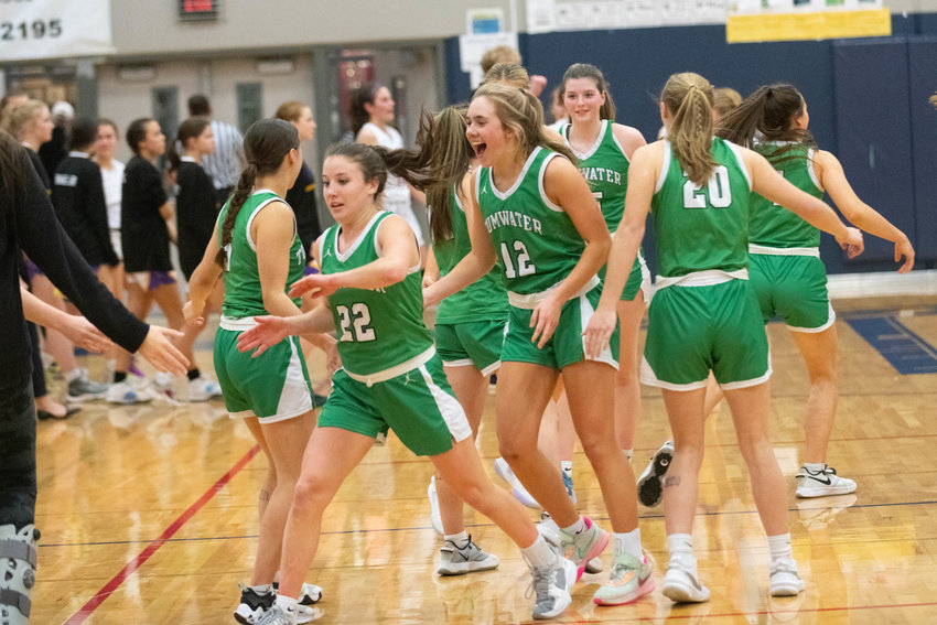 Regan Brewer (22), Rhylee Beebe (12) and the rest of the Tumwater Thunderbirds celebrate at the buzzer of their 49-39 win over Columbia River in the 2A district semifinals on Feb. 13 at Black Hills