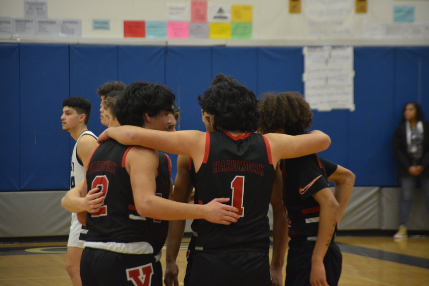Yelm&rsquo;s varsity basketball team huddles before its game against River Ridge on Feb. 2.