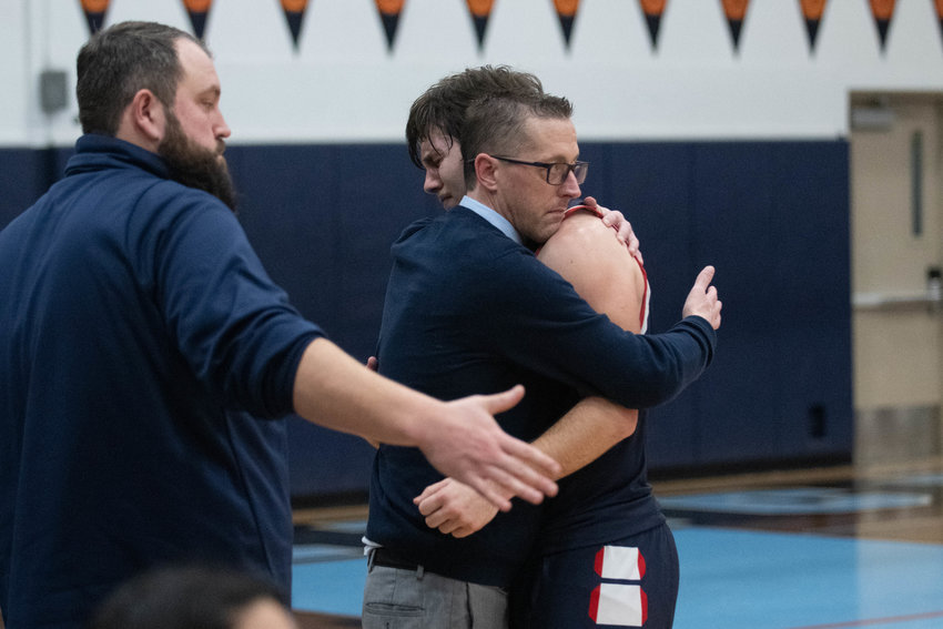 Black Hills' Johnnie Stallings hugs coach Jeff Gallagher after getting subbed out late in the fourth quarter of the Wolves' 54-30 loss to Ridgefield in a 2A district loser-out matchup, at Mark Morris on Feb. 16.