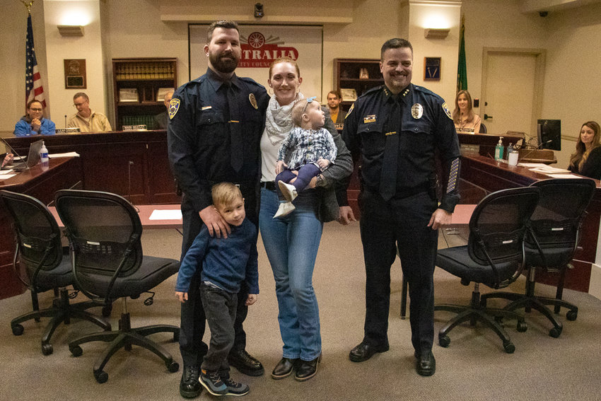 Centralia Police Officer Daniel Cox poses with his wife Melissa Cox, their children, Thomas and Vivian, and Chief Stacy Denham following his swearing in ceremony Tuesday night at Centralia City Hall.