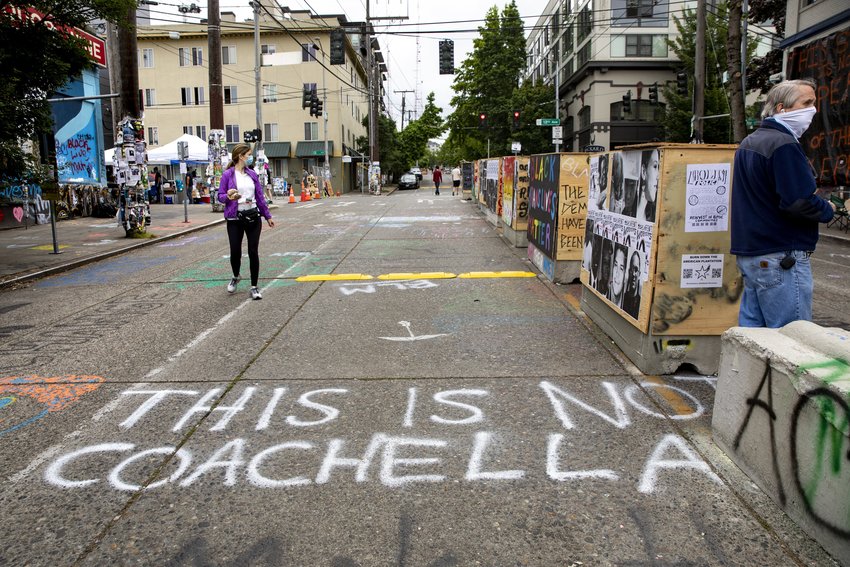 &quot;This is not Coachella,&quot; reads graffiti at the CHOP, or Capitol Hill Organized Protest, previously known as CHAZ, on June 21, 2020, in Seattle. (Bettina Hansen/Seattle Times/TNS)