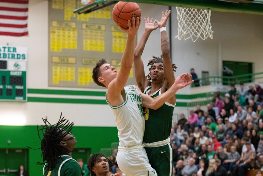 Andrew Collins goes through contact on a transition layup for an old-fashioned three-point play during the first half of Tumwater's matchup against Foss in the opening round of the 2A state boys basketball tournament, on Feb. 25.