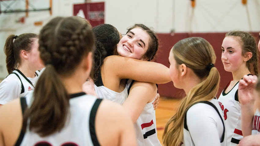 Mossyrock senior Payton Torrey (5) receives an embrace after defeating the Nighthawks Saturday night in Chehalis.