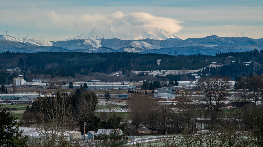 Clouds shroud Mount Rainier as snow sticks to the ground across Lewis County in this photo captured west of Chehalis Thursday morning.