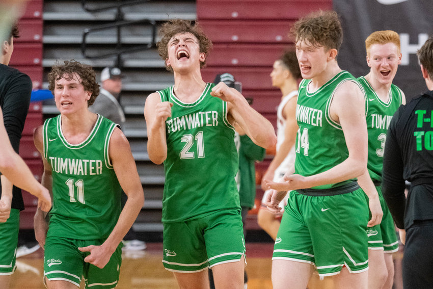Luke Brewer (11), Connor Hopkins (21), and Gunnar Harroun (14) celebrate at the buzzer of Tumwater's 56-53 win over Renton in the Round of 12 at the 2A state tournamet in Yakima on March 1.